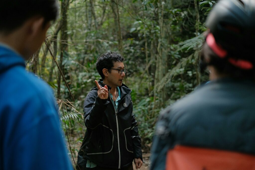 pexels photo 37025848 37025848 A guide leading a group of people on an informative nature walk in a dense forest.